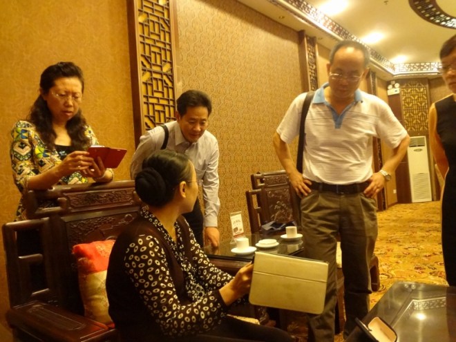 Chancellor of Wuyi University WANG Ke showing pictures of Barkerville on my Ipad to her colleagues