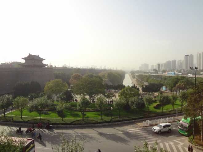 View along the outside of the wall and moat. The outside of the wall is surrounded by park