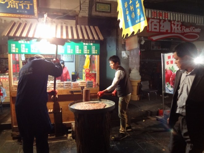 I think they are making a similar halvah like candy, but by pounding it with wooden hammers instead of pulling.